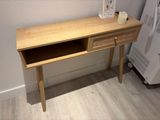 a wooden desk with a drawer on top of it
