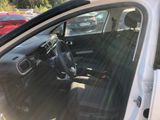 the interior of a white car with the sun shining through the window