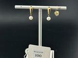 a close up of a pair of earrings on a stand