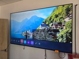 a flat screen tv hanging on a wall in a room