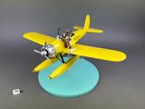 toy airplane with pilot and pilot on board sitting on blue base