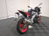 a red and black motorcycle parked on a black and white checkered floor