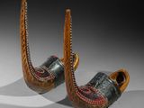 pair of wooden shoes with red and green designs on them