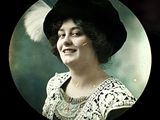 a black and white photo of a woman with a feather in her hair