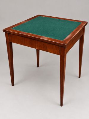 a small wooden table with a green top and legs