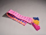 a close up of a pink and blue tie with pom poms on it