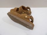 brown leather sandals on a white surface with a white background