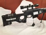 the rifle is sitting on a bed with a scope on it