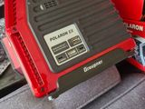 a red and black radio sitting on the back of a car
