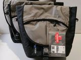 a bag that is sitting on a table with a tag attached to it