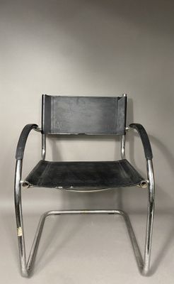 an image of a black leather and chrome chair against a white wall