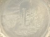 a silver plate with a picture of jesus on it