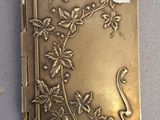 a gold case with a floral design on it