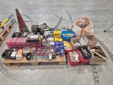 a lot of assorted items on a pallet in a warehouse