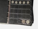 a black book with a bunch of coins inside of it