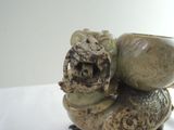 a statue of a dragon with a bowl on it ' s back