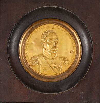 a picture of a gold medal with a picture of a man on it