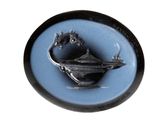 a picture of a black and blue plate with a bird on it
