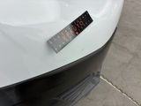 a sticker on the hood of a white car