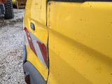 a close up of a yellow truck with a red and white stripe on it
