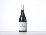 a bottle of red wine sitting on top of a table