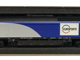 un petit train dans une boîte noire posée sur une surface blanche