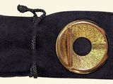 a black bag with a gold ring on it