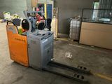 a forklift that is sitting in the middle of a warehouse