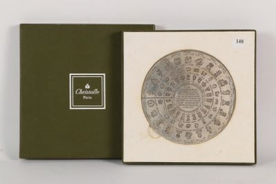 a box with a silver coin in it on a white surface