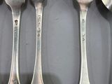 five forks and spoons that are on a table