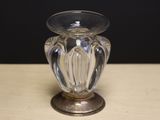 a glass vase sitting on a table with a black background