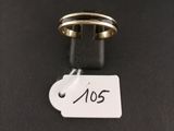 a close up of a ring on a black surface with a tag