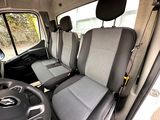 two seats in the back of a van with a steering wheel