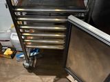 several trays of food are stacked on a cart in a kitchen