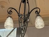 a chandelier hanging from the ceiling in a room