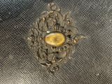 a metal object with a gold eye on it