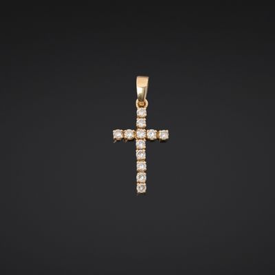 a diamond cross pendant on a black background