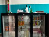 two refrigerators that are sitting in a room