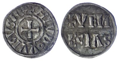 a silver coin with a cross on the front and a cross on the back