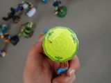 a person holding a small toy in their hand