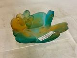 a glass figurine of a cat laying on its back