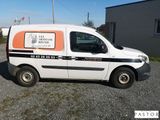 a van that is parked on the gravel road