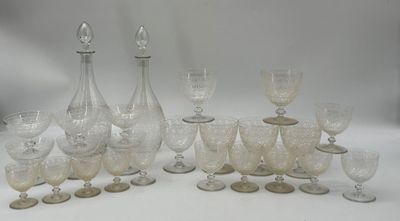 a lot of wine glasses and a decanter on the table