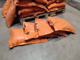 several bags of sand sitting on top of a pallet in a warehouse