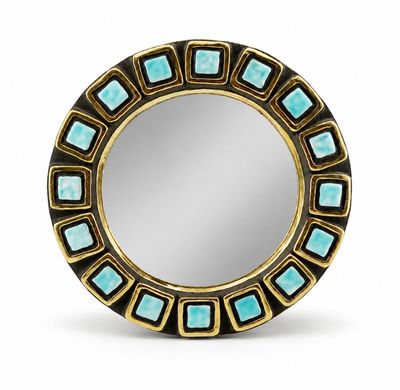 a close up of a round mirror with a gold frame