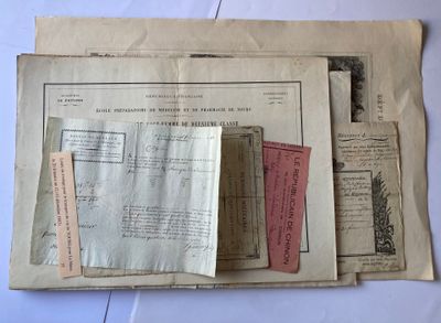 some old papers are stacked on top of each other on a table