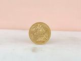 a gold coin sitting on top of a marble counter