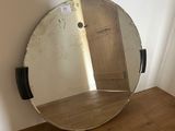 a mirror that is sitting on a wooden table