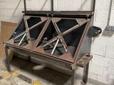 an image of a metal table with two bins on it
