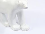 a white ceramic polar bear statue on a white background